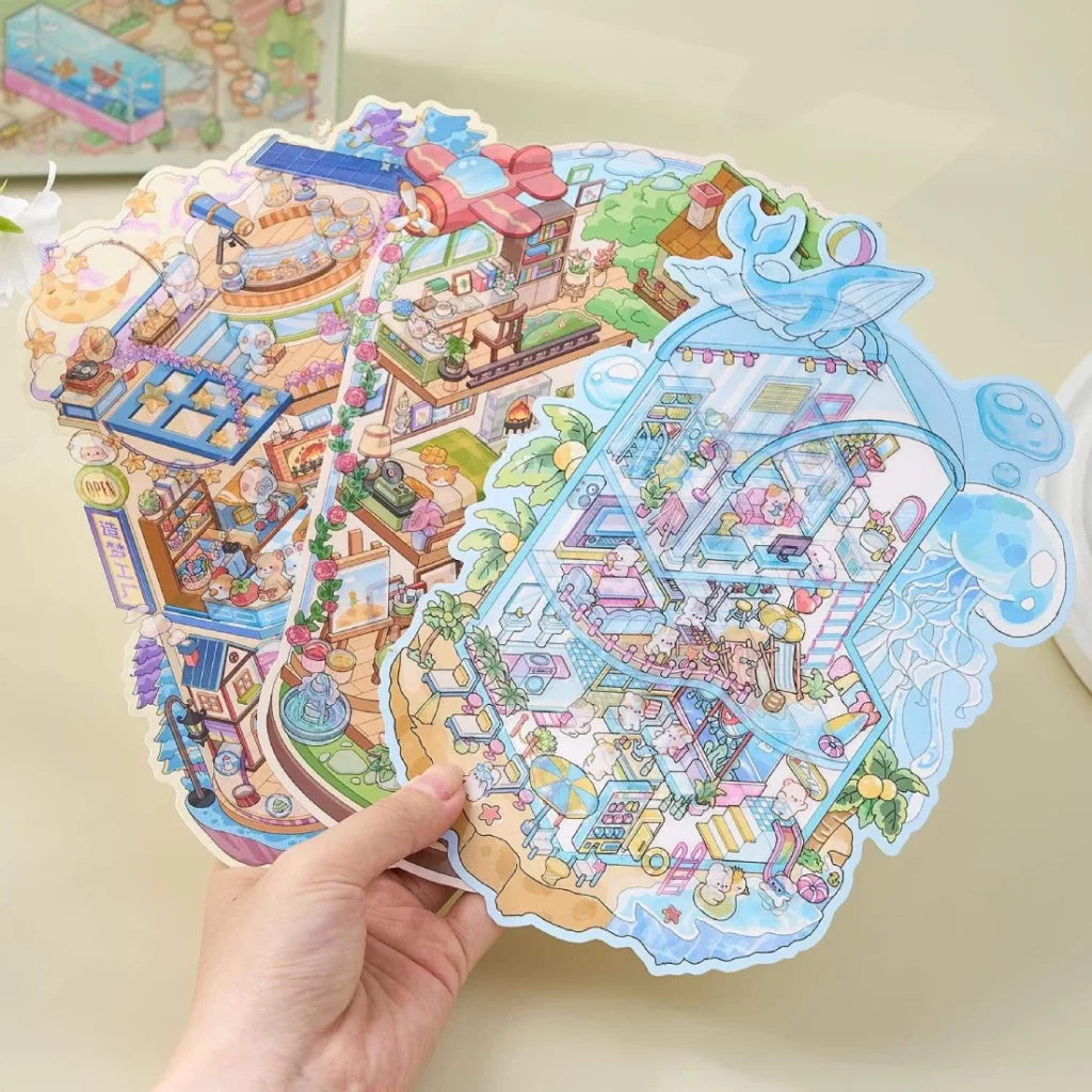 Carnet à spirales contenant 6 scènes de stickers isométrique 3D à composer soi-même sur le thème des maisons. Activité créative pour adulte pour gérer le stress.