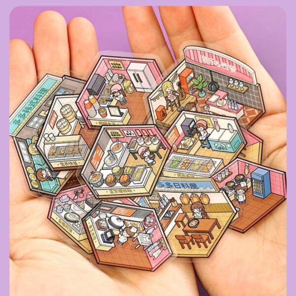 Carnet à spirales contenant 7 scènes de stickers isométrique 3D à composer soi-même sur le thème de la ville. Activité créative pour adulte pour gérer le stress.